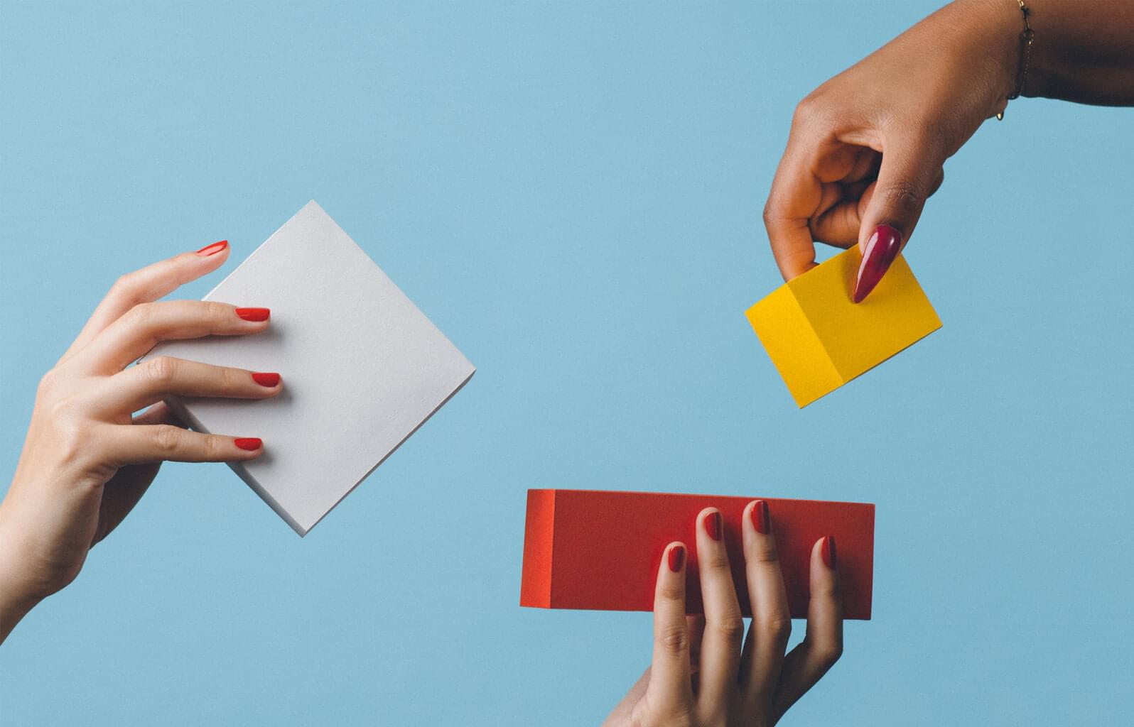 Decorative image: hands holding different blocks.